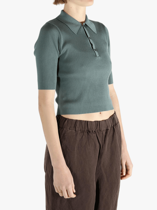 Green polo worn by a person, showing the polo's fit