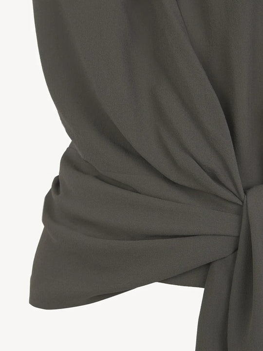 Close up of grey top, showing texture of the fabric