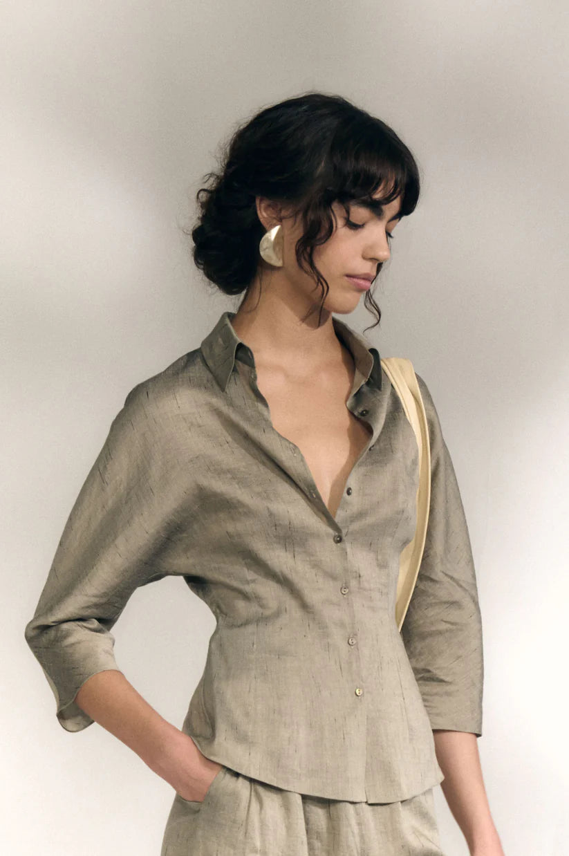 Grey shirts worn by a person, showing the shirts fit