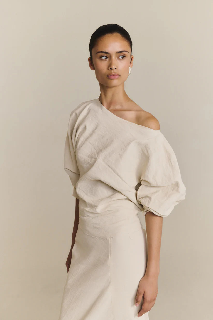 White top worn by a person, showing the top fit