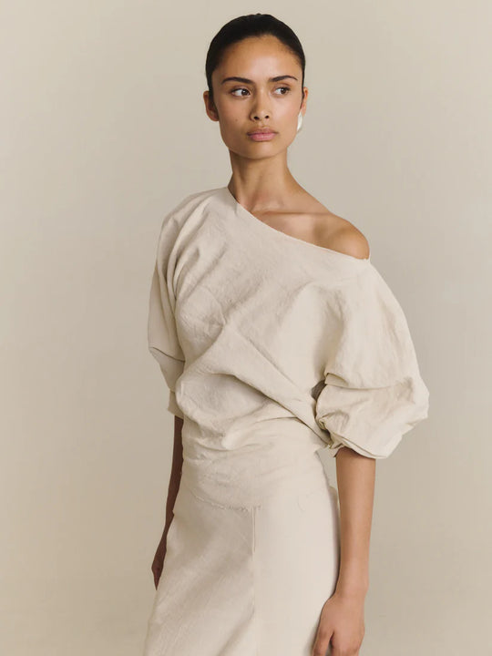 White top worn by a person, showing the top fit