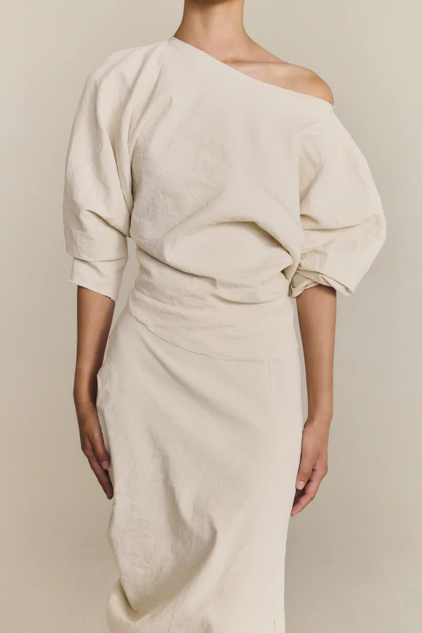 White top worn by a person, showing the top fit