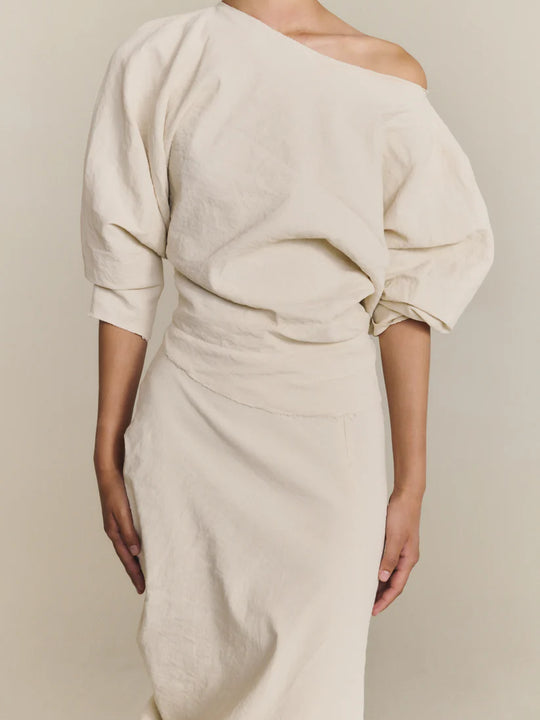 White top worn by a person, showing the top fit