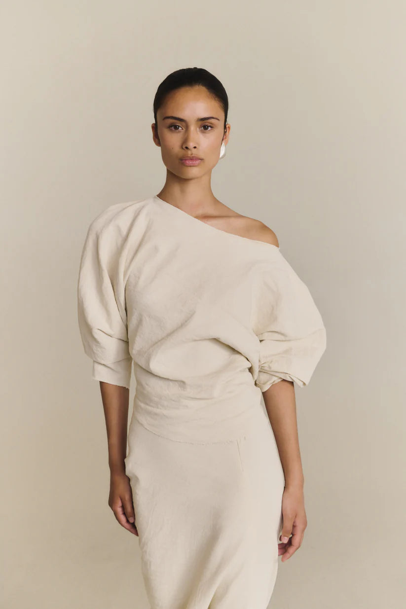 White top worn by a person, showing the top fit