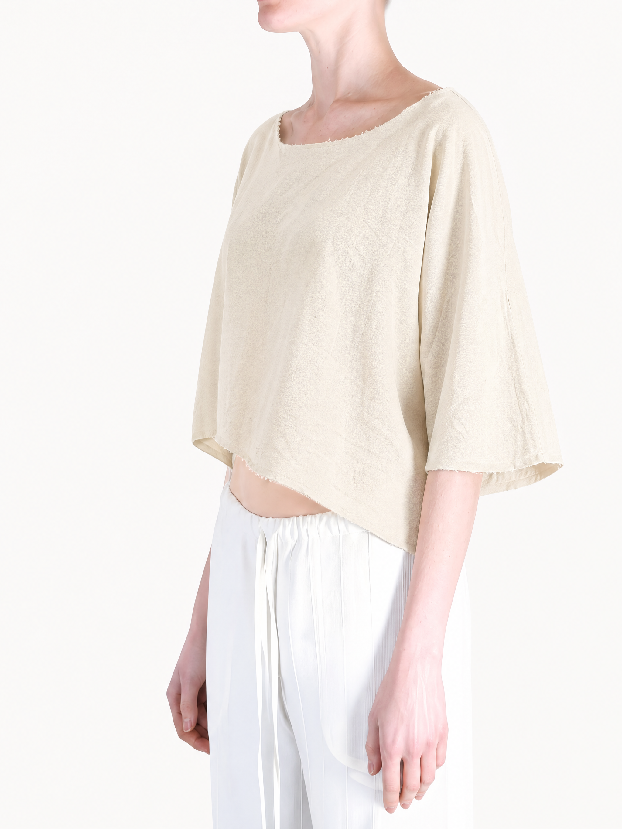Tan top worn by a person, showing the top fit