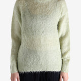 White knitwear worn by a person, showing the knitwear's fit