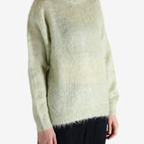 White knitwear worn by a person, showing the knitwear's fit