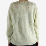 White knitwear worn by a person, showing the knitwear's fit