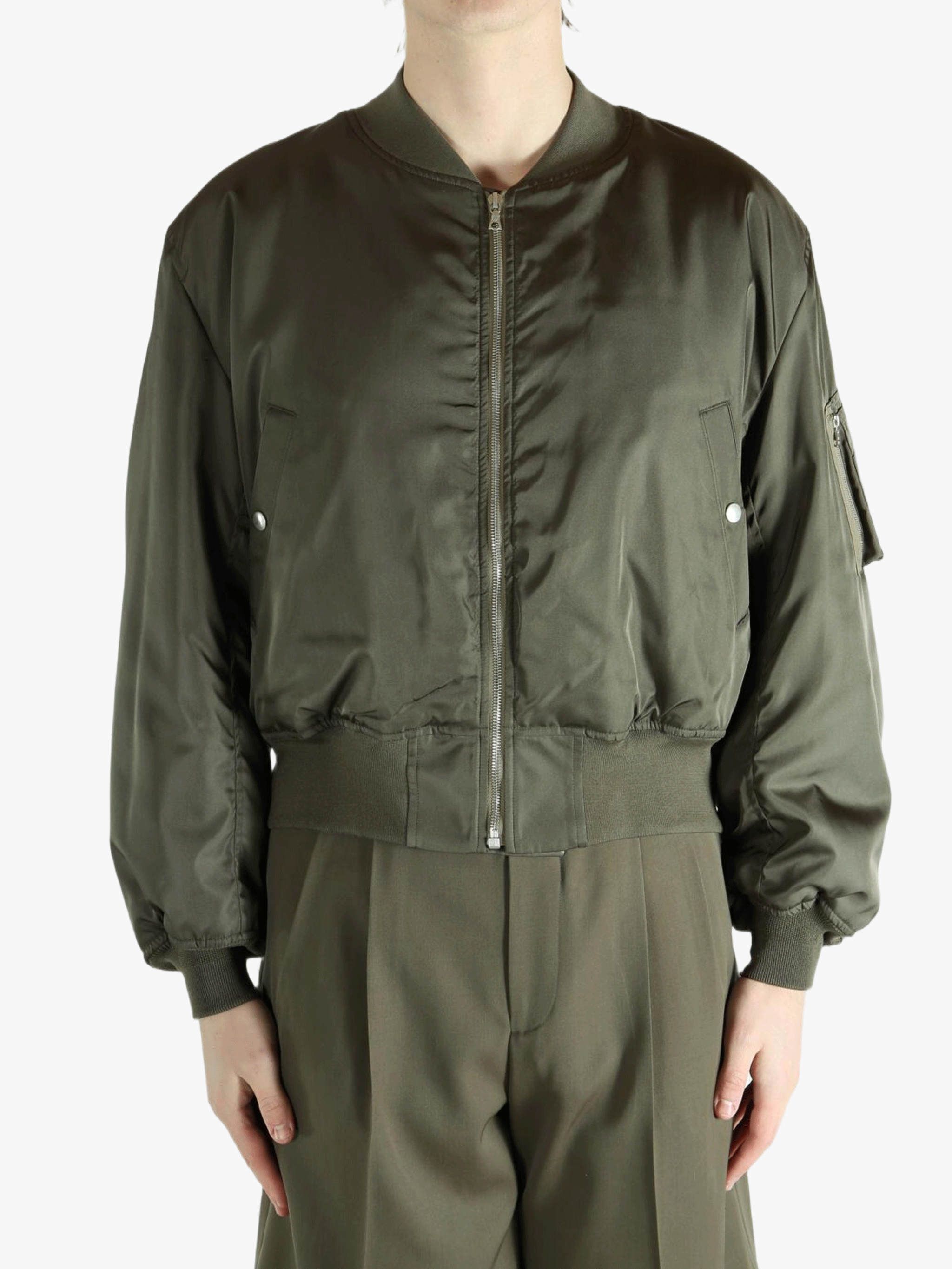 Green jacket worn by a person, showing the jacket's fit