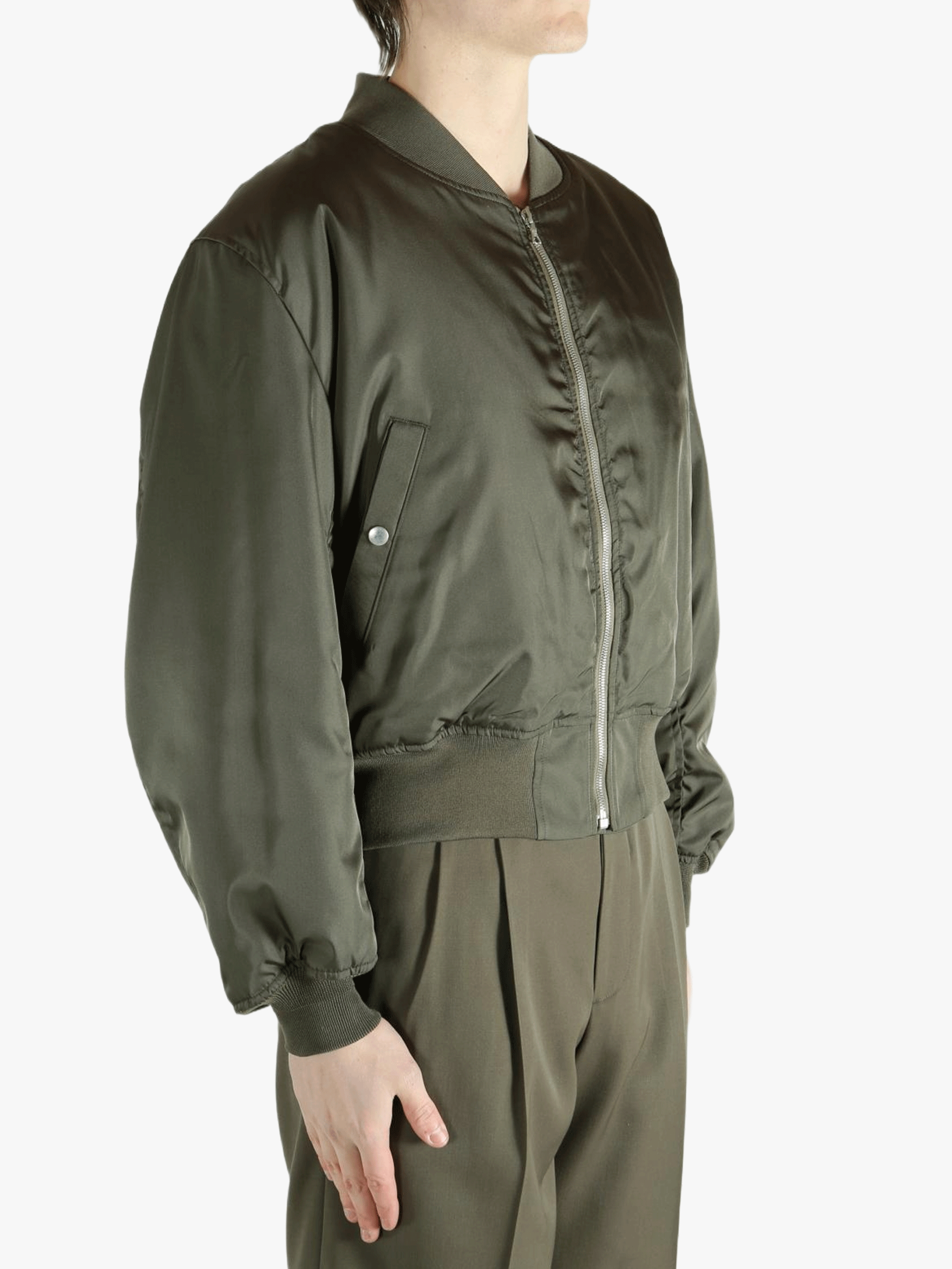 Green jacket worn by a person, showing the jacket's fit