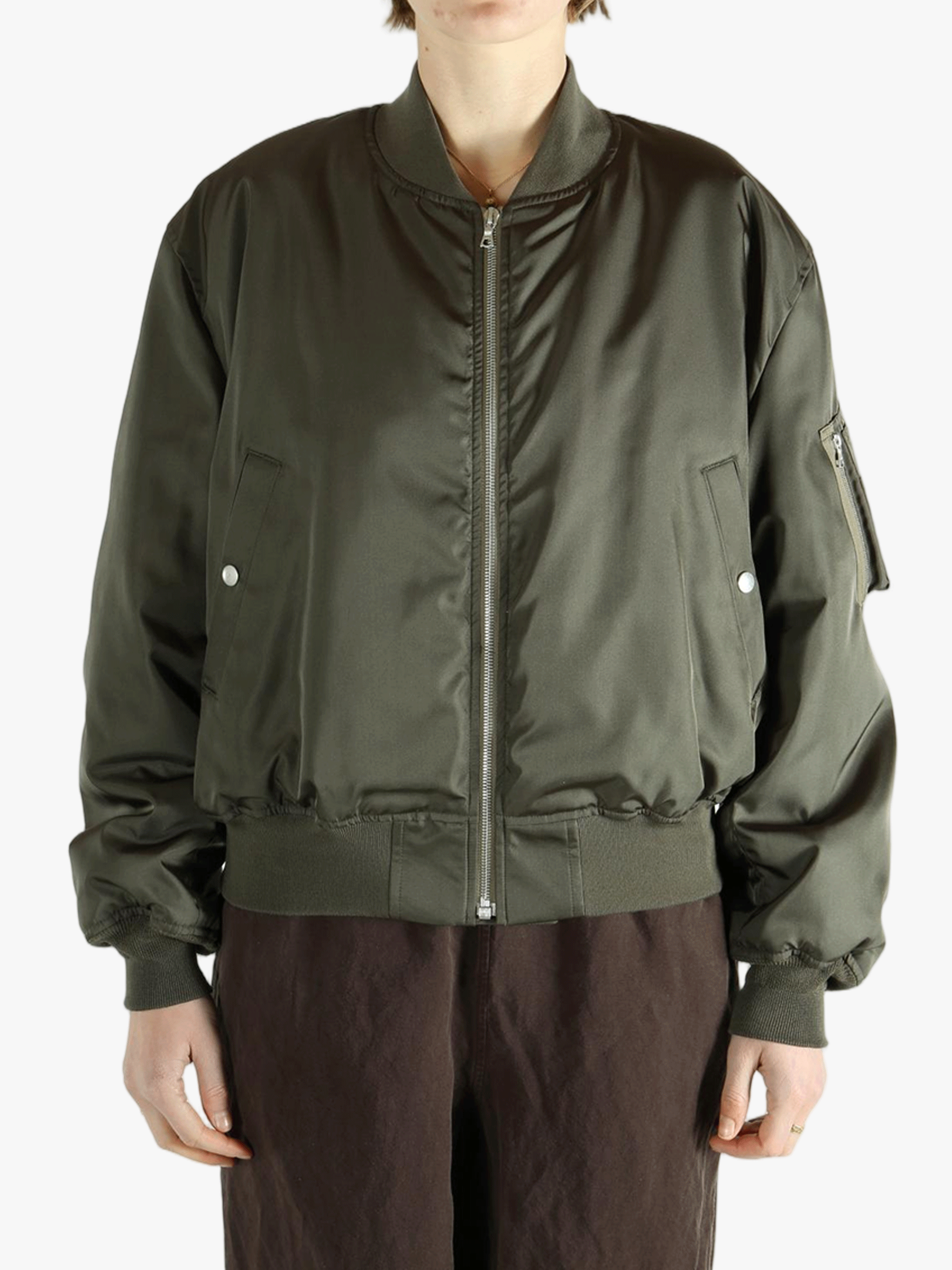 Green jackets-coats worn by a person, showing the jackets-coats's fit