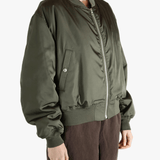 Green jackets-coats worn by a person, showing the jackets-coats's fit