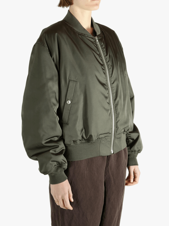 Green jackets-coats worn by a person, showing the jackets-coats's fit