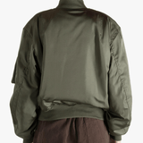 Green jackets-coats worn by a person, showing the jackets-coats's fit