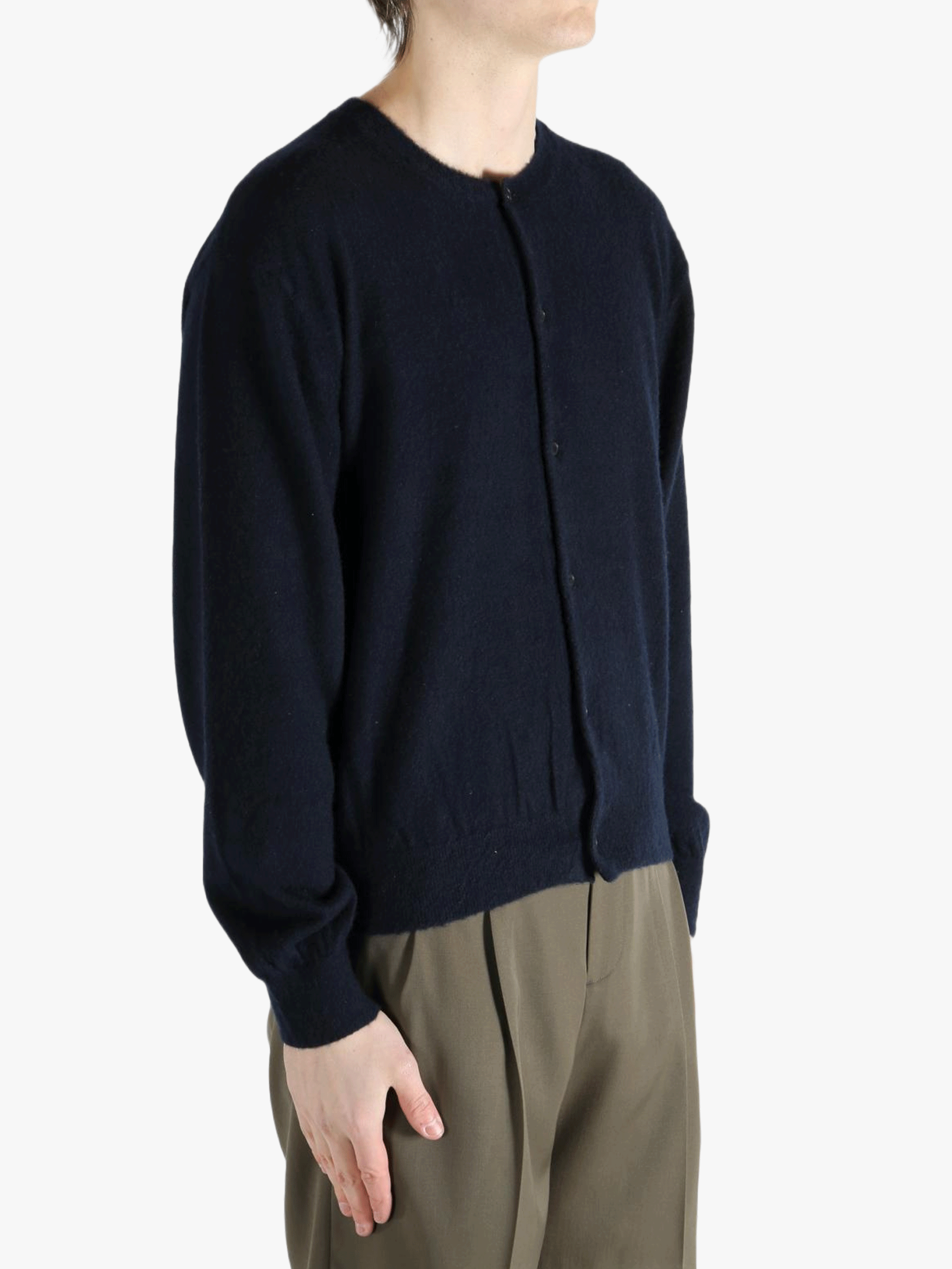 Navy knitwear worn by a person, showing the knitwear's fit