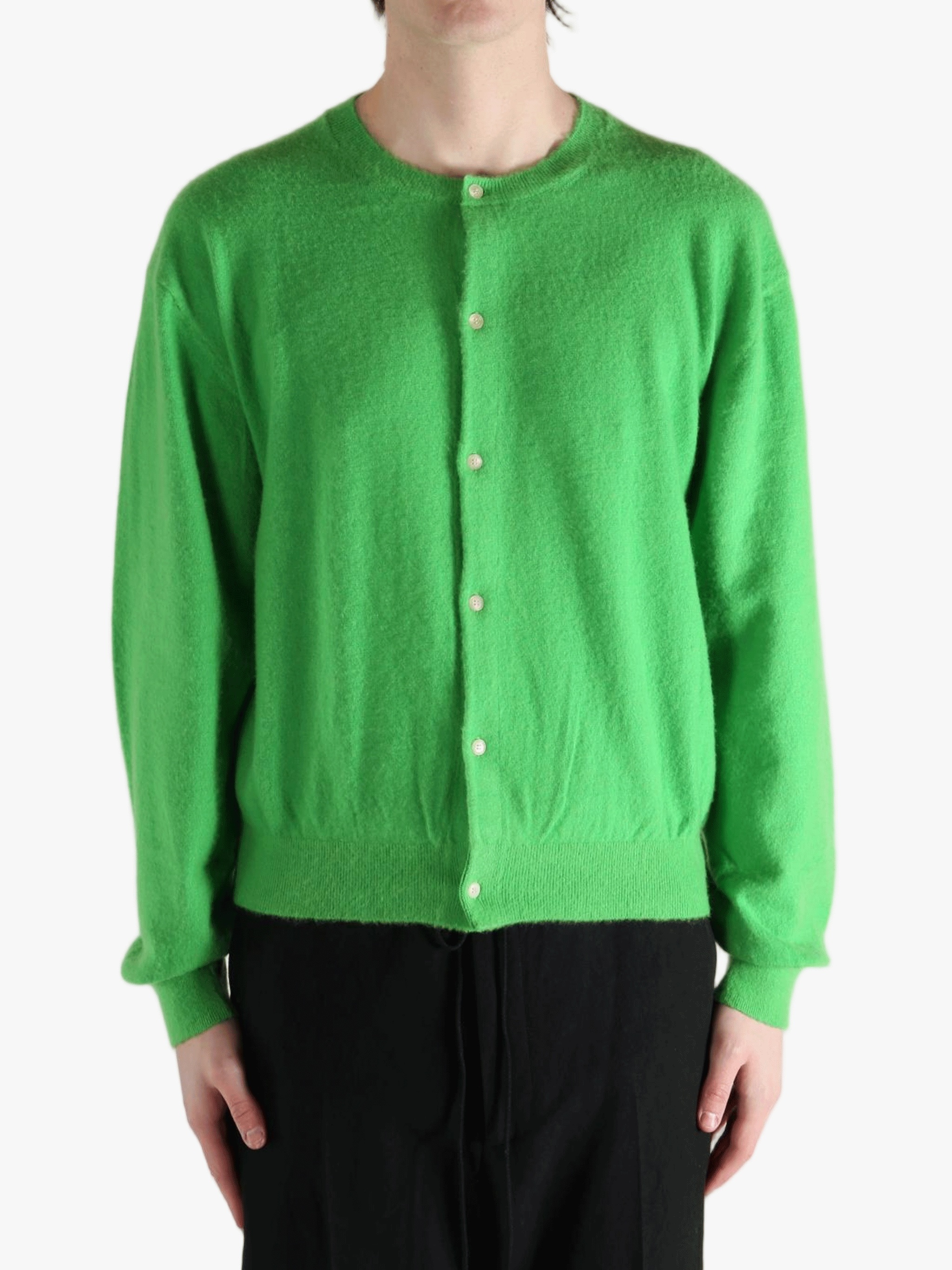 Green knitwear worn by a person, showing the knitwear fit
