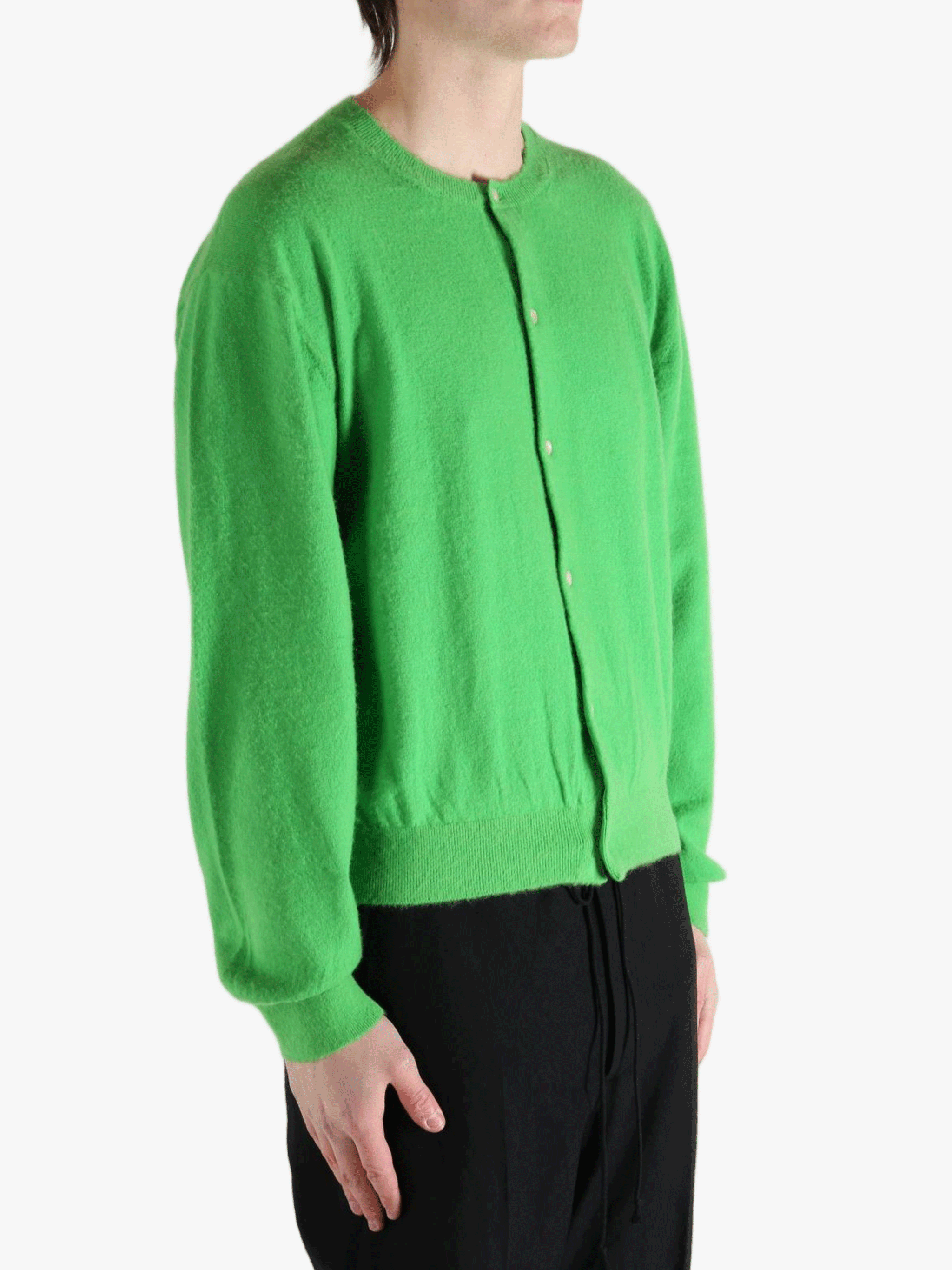 Green knitwear worn by a person, showing the knitwear fit