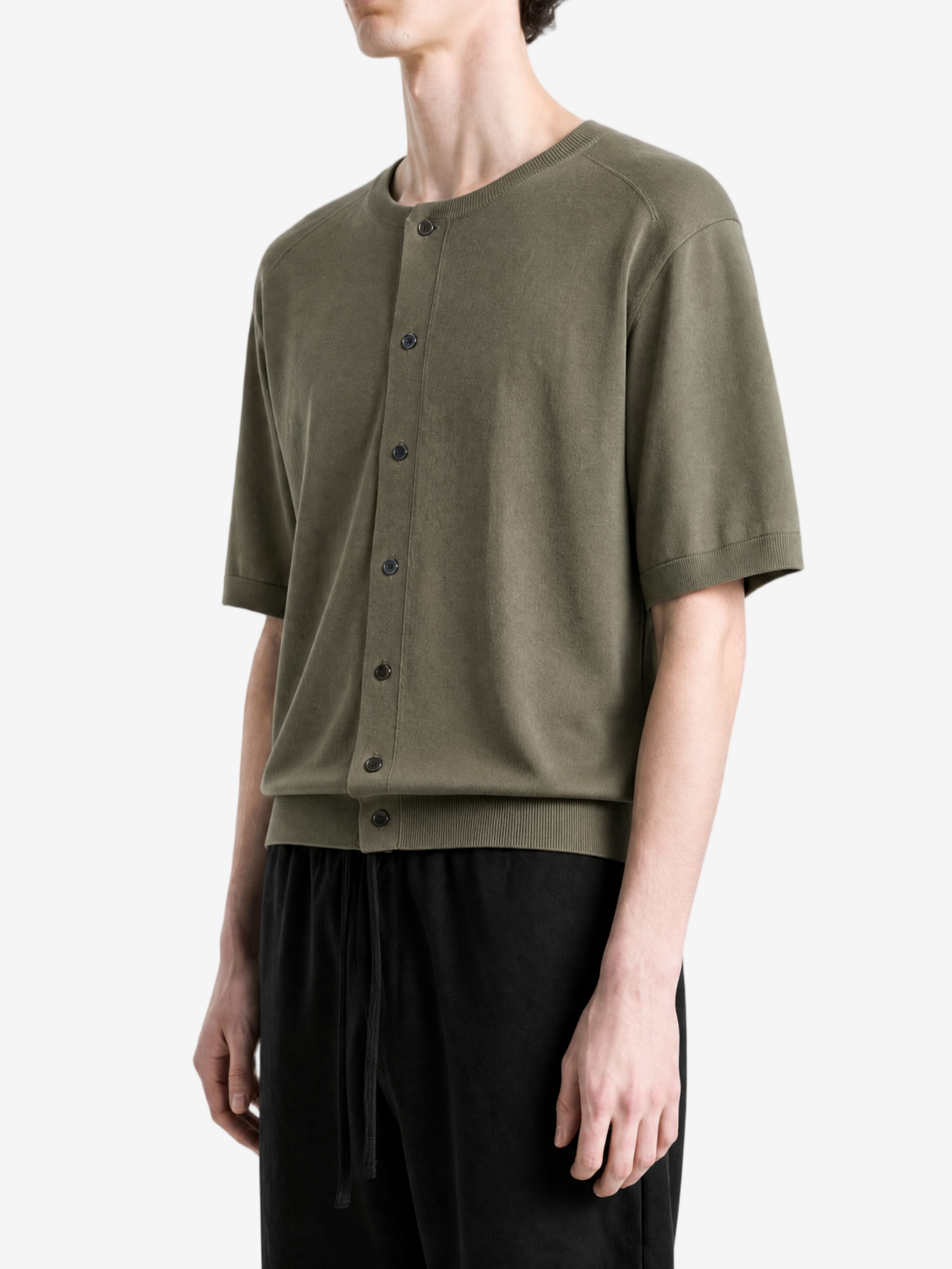 Green knitwear worn by a person, side view
