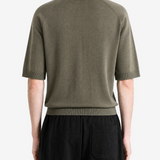 Green knitwear worn by a person, back view