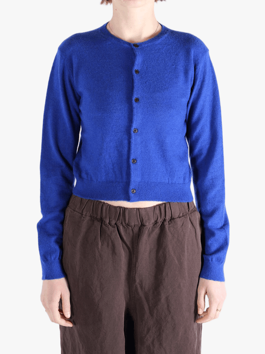 Blue knitwear worn by a person, showing the knitwear's fit