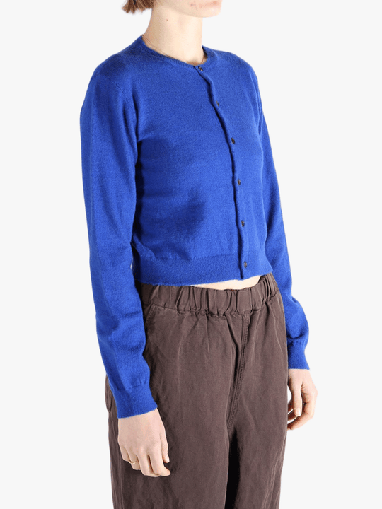 Blue knitwear worn by a person, showing the knitwear's fit
