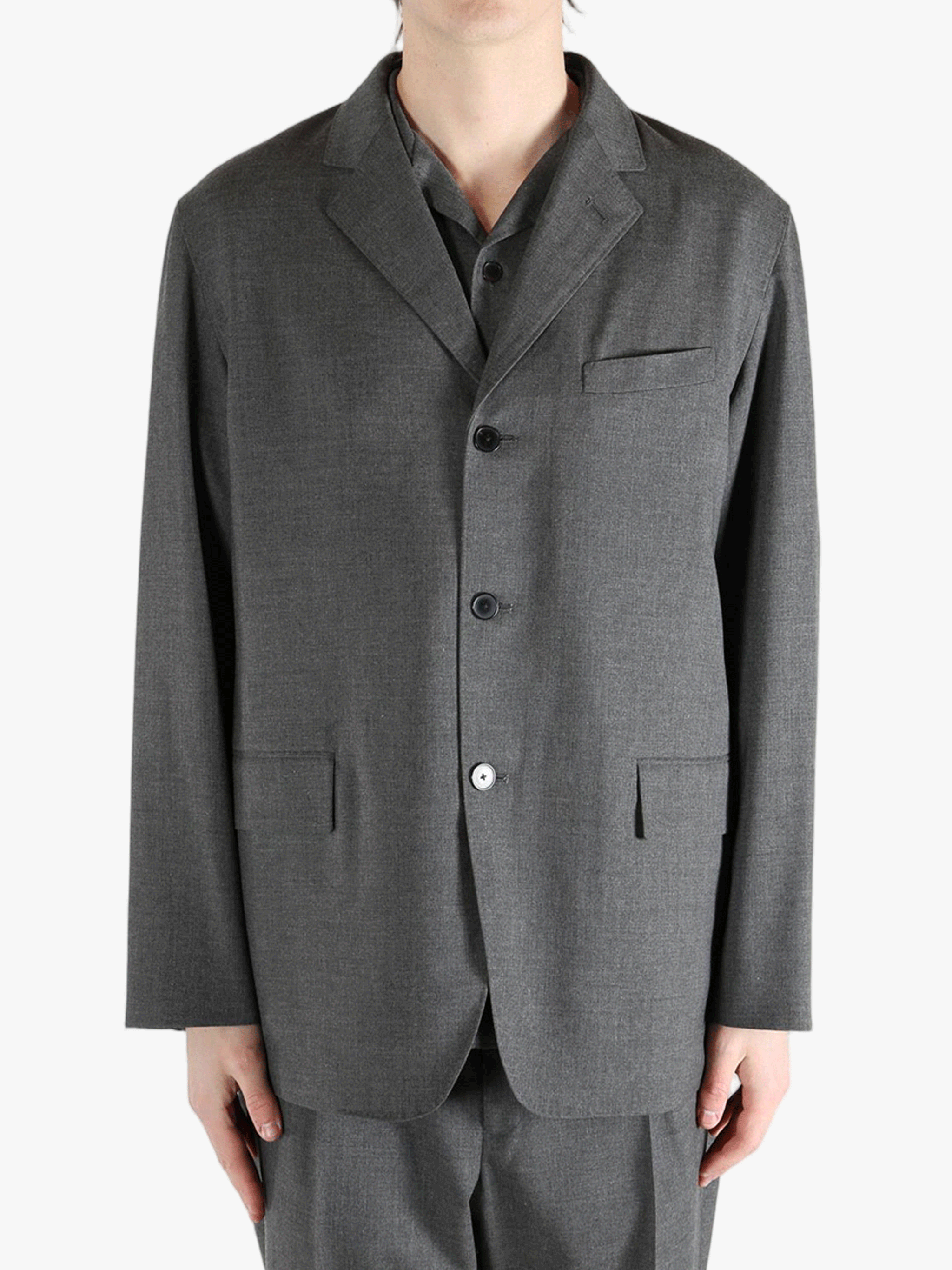 Grey jacket worn by a person, showing the jacket's fit