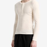 Tan top worn by a person, side view