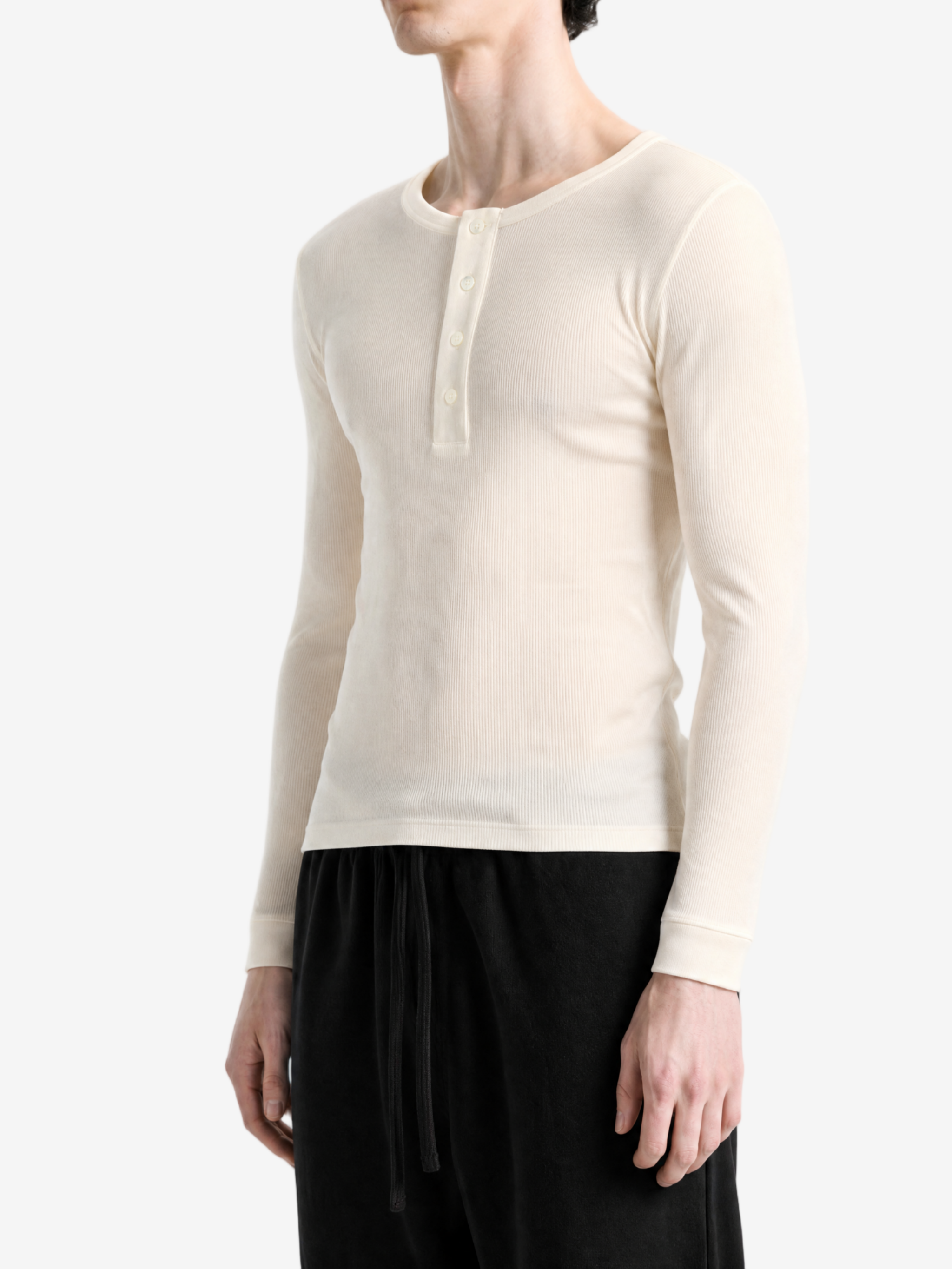 Tan top worn by a person, side view