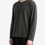 Black t-shirt worn by a person, side view