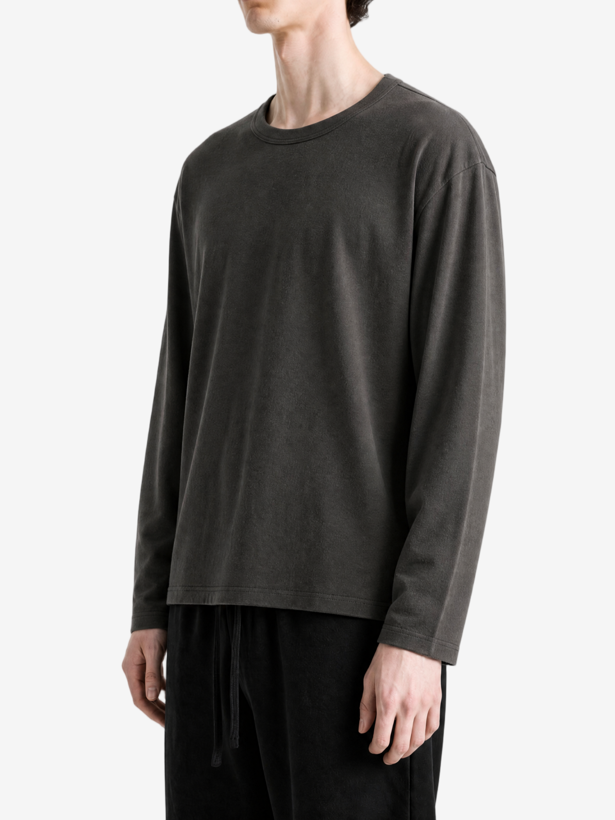 Black t-shirt worn by a person, side view