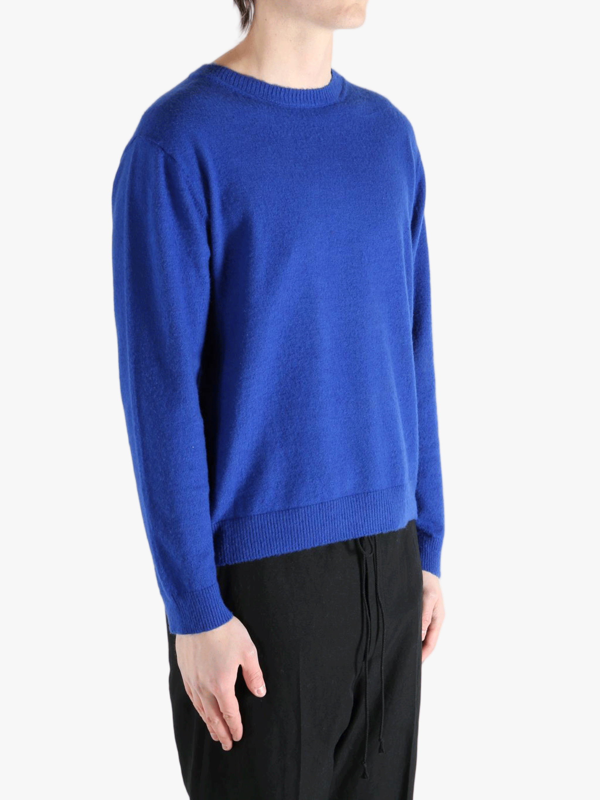 Blue knitwear worn by a person, showing the knitwear fit