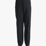 Black pants worn by a person, showing the pants fit