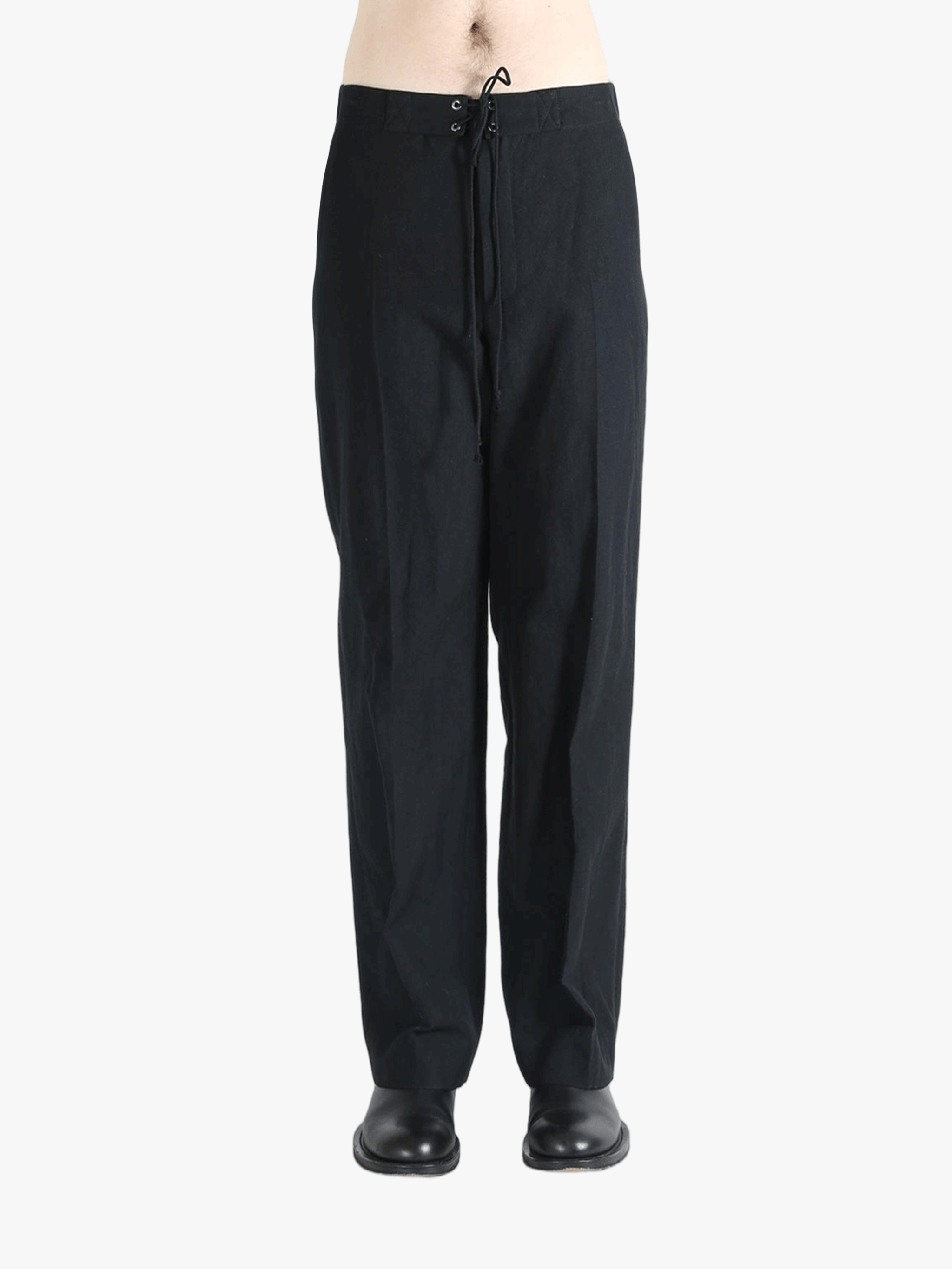 Black pants worn by a person, showing the pants fit