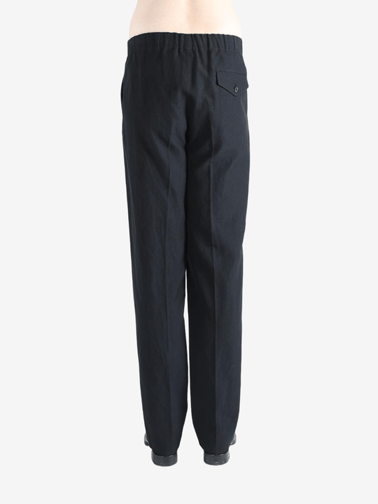 Black pants worn by a person, showing the pants fit