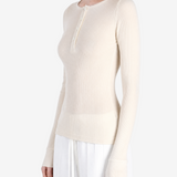 Tan top worn by a person, side view