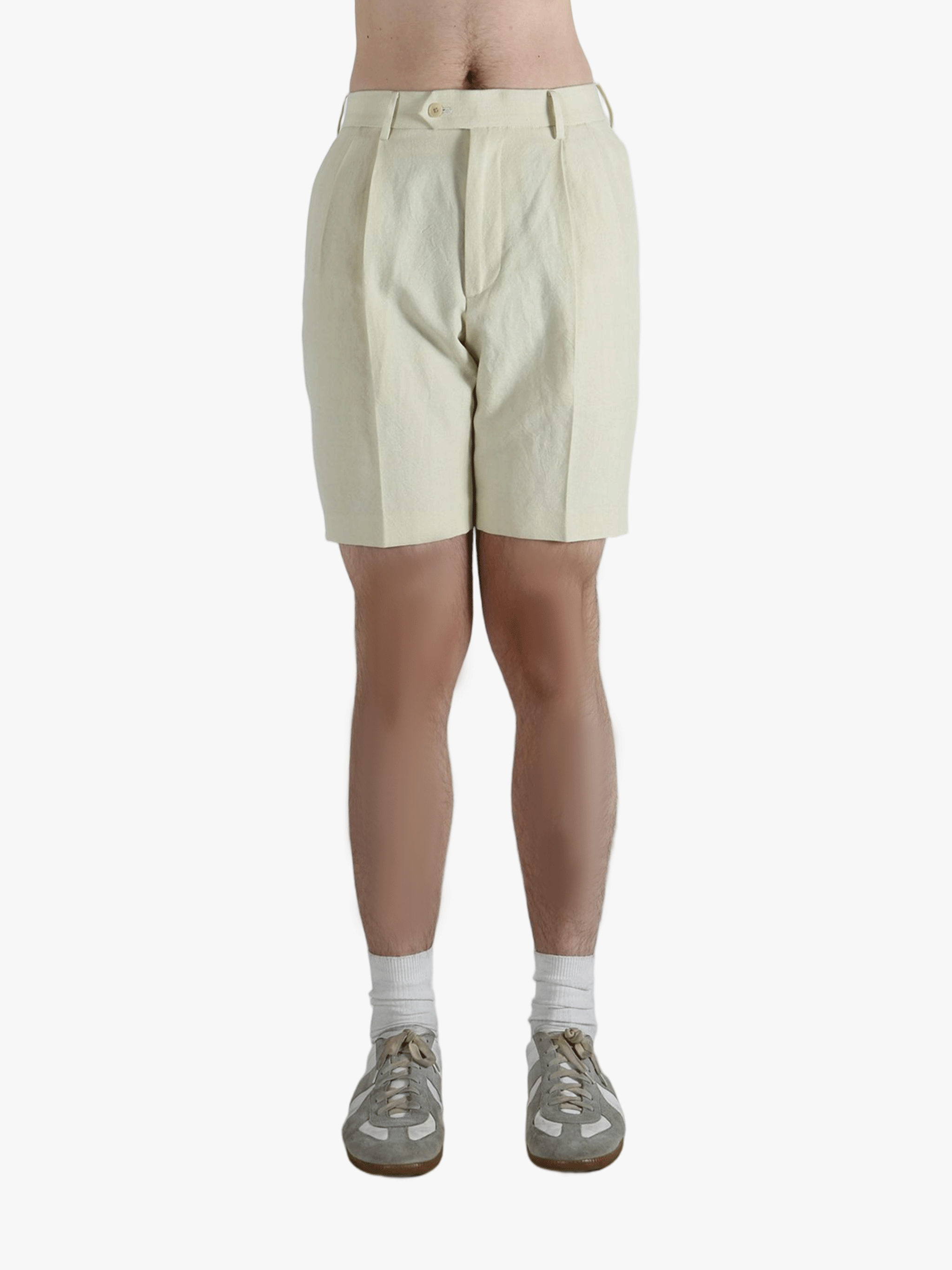 Tan shorts worn by a person, showing the shorts' fit