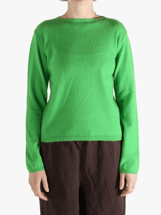 Green knitwear worn by a person, showing the knitwear's fit
