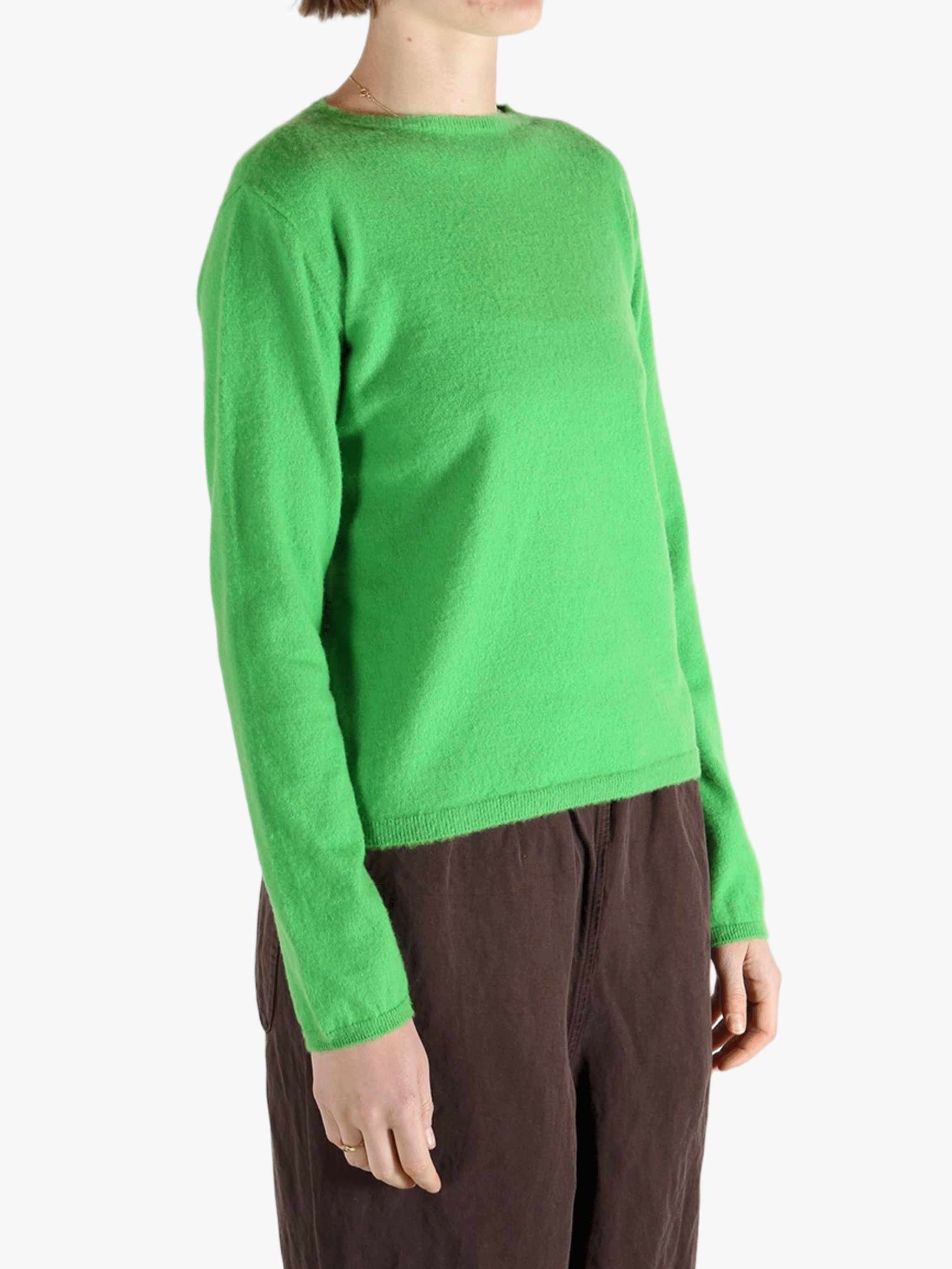 Green knitwear worn by a person, showing the knitwear's fit