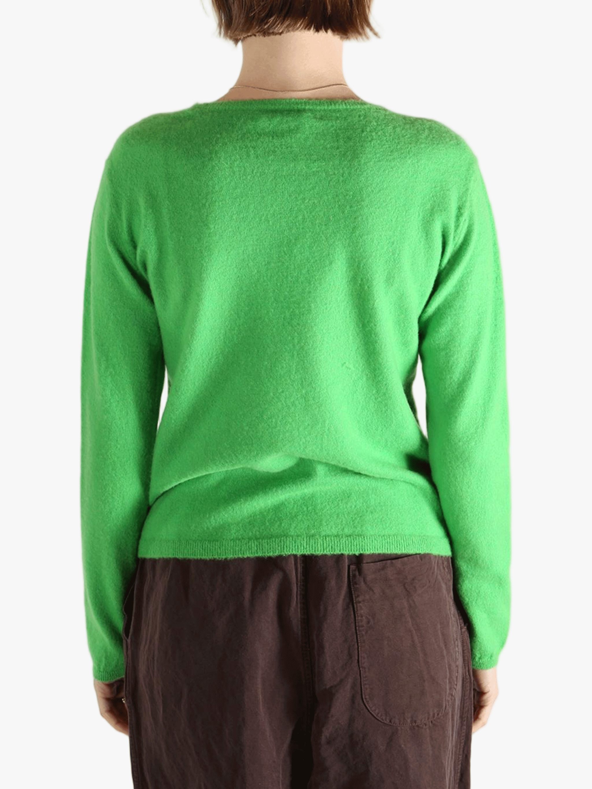 Green knitwear worn by a person, showing the knitwear's fit
