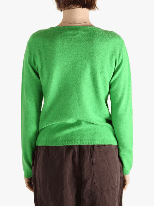 Green knitwear worn by a person, showing the knitwear's fit