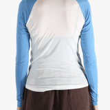 White top worn by a person, showing the top's fit