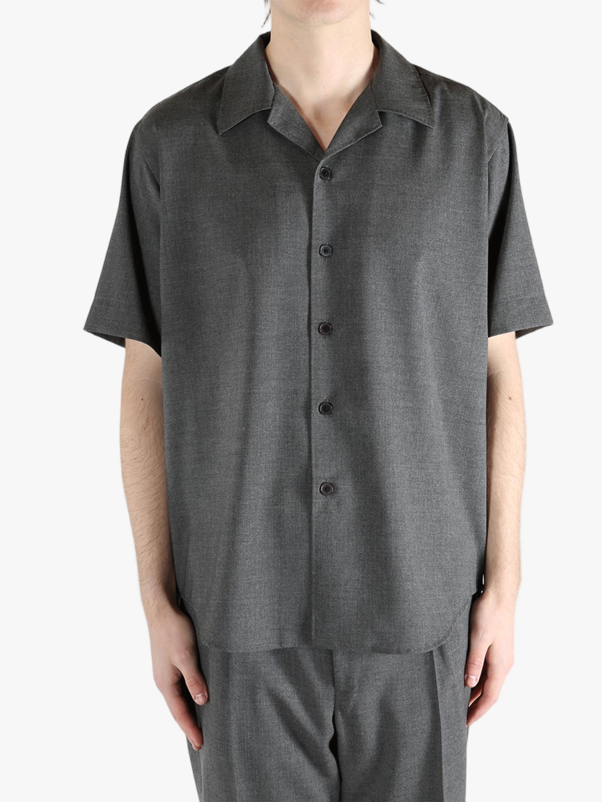 Grey shirts worn by a person, showing the shirt's fit