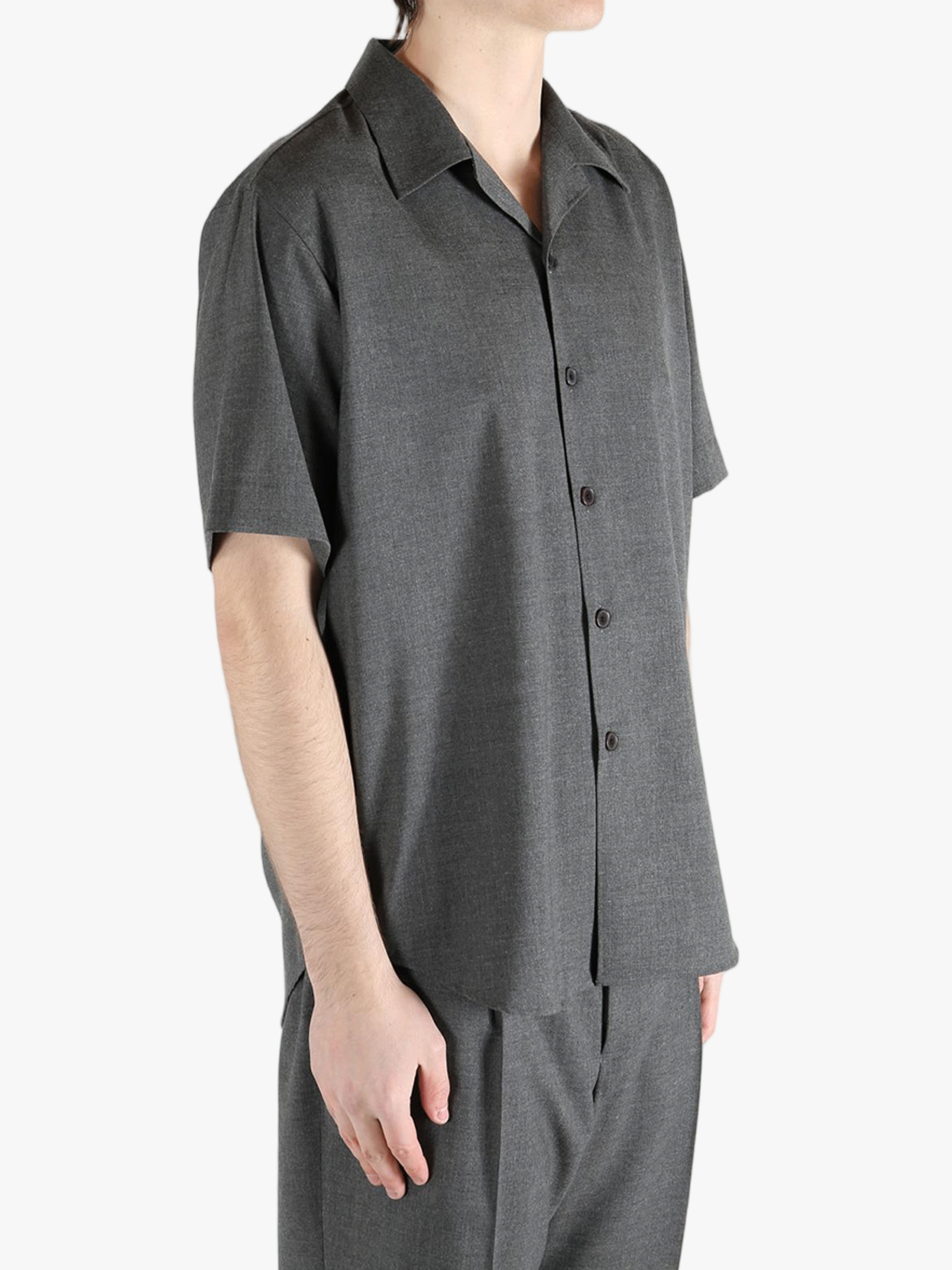 Grey shirts worn by a person, showing the shirt's fit