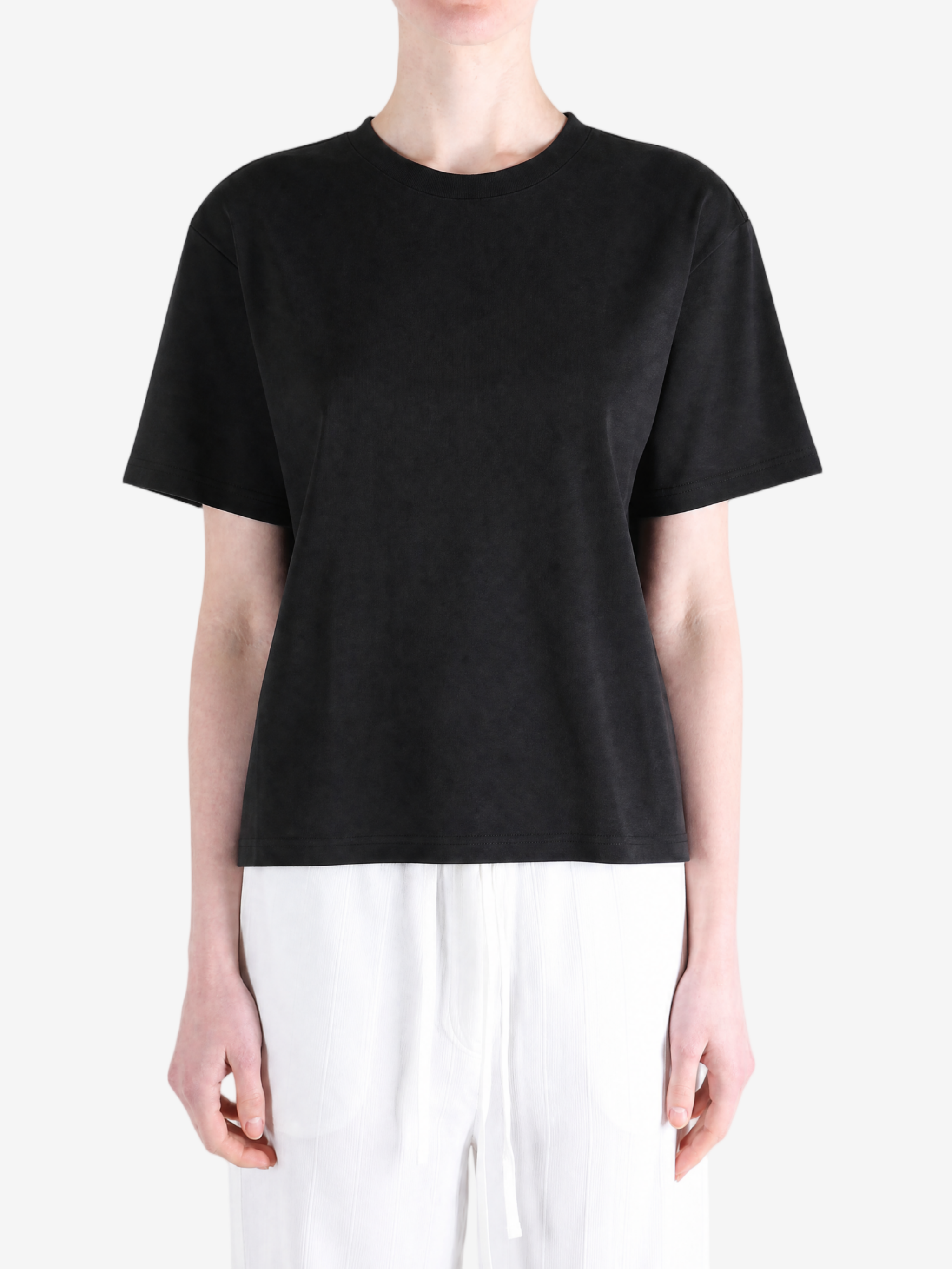 Black t-shirt worn by a person, showing the t-shirt's fit