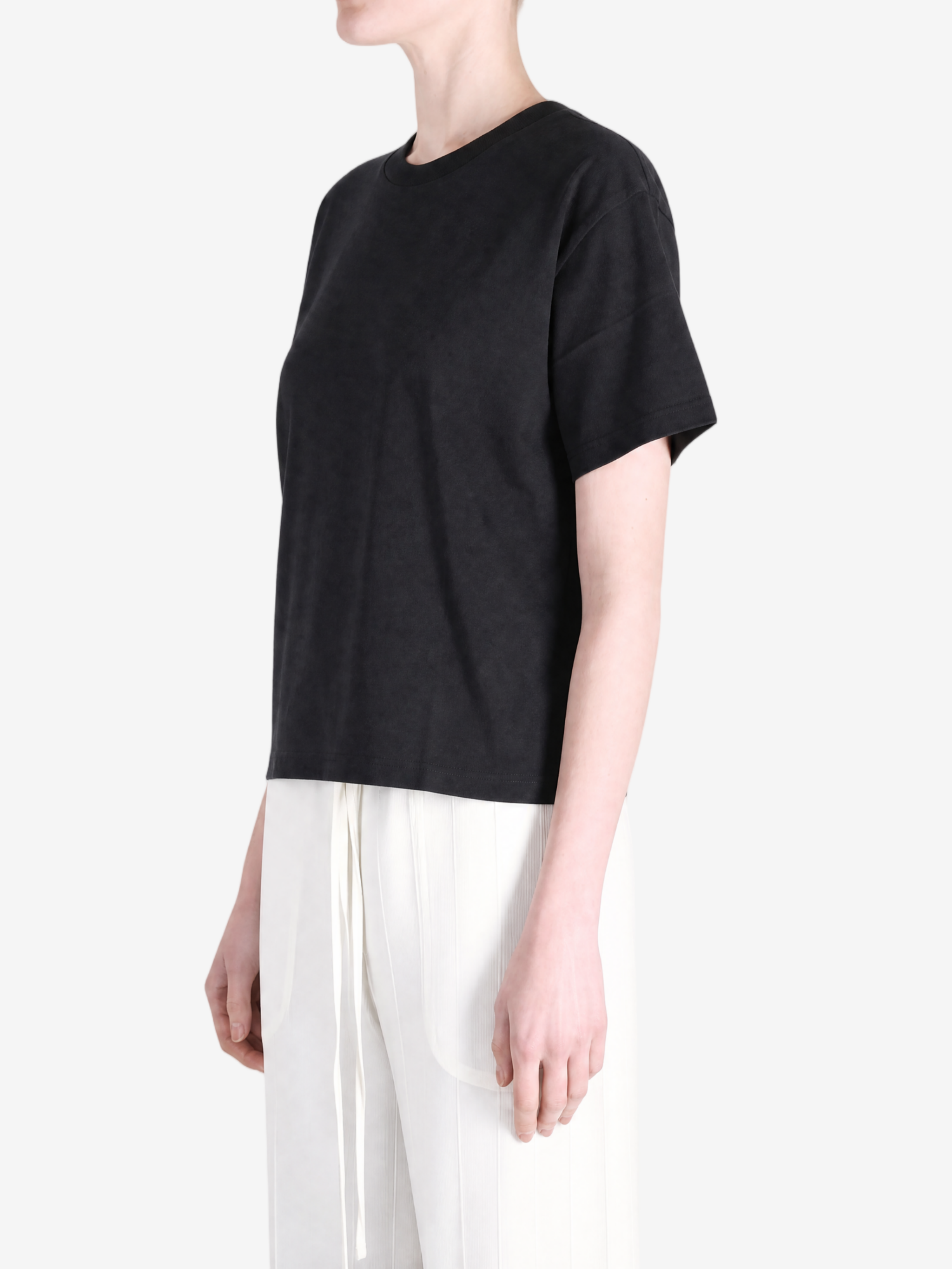 Black t-shirt worn by a person, showing the t-shirt's fit