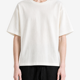 White t-shirt worn by a person, showing the t-shirt fit
