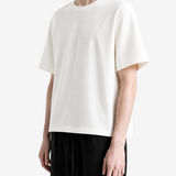 White t-shirt worn by a person, side view