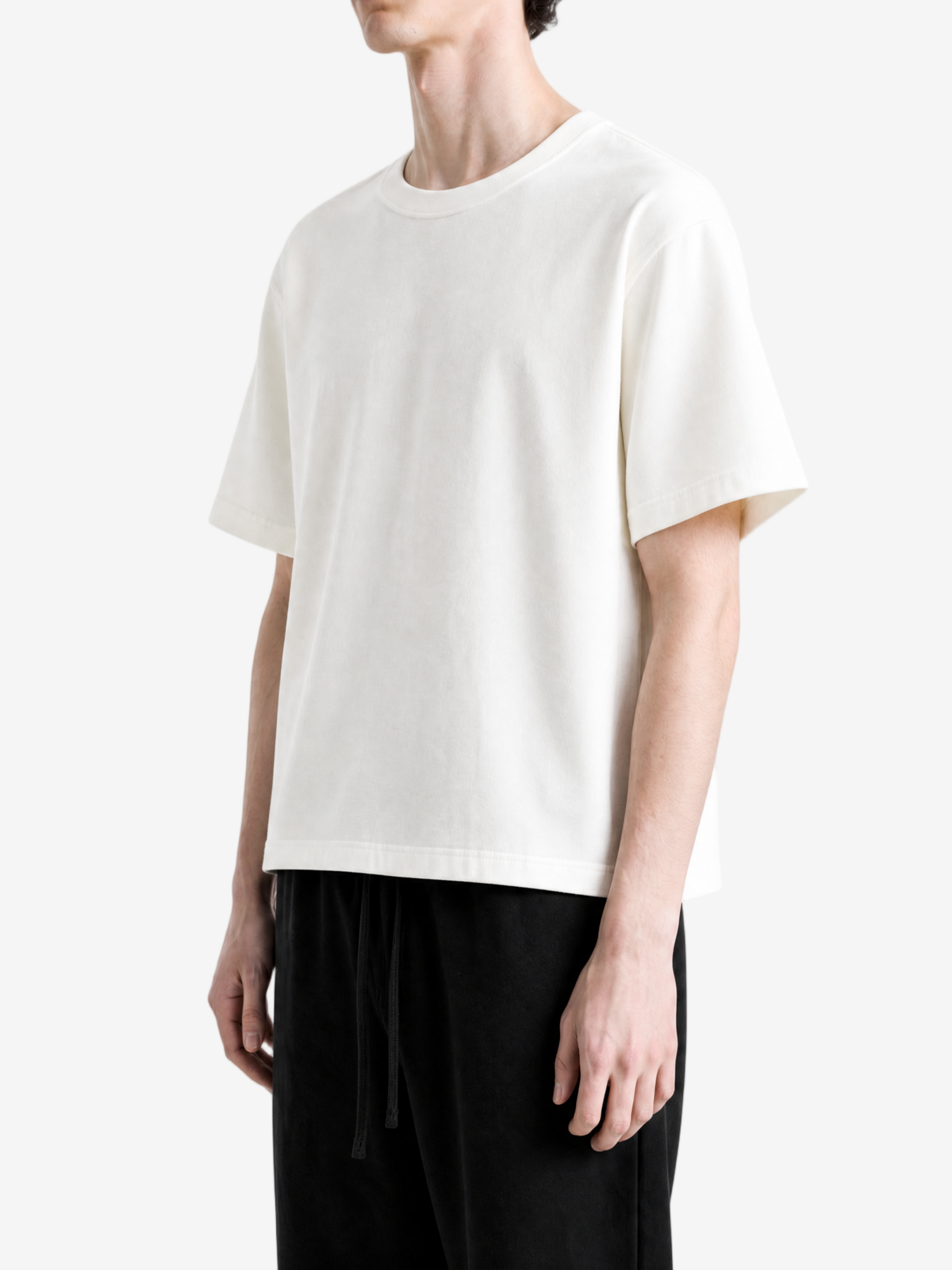 White t-shirt worn by a person, side view