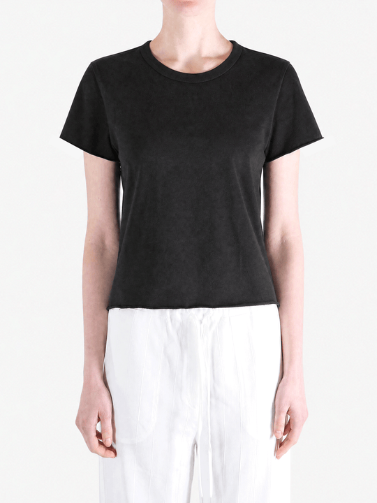 Black tee worn by a person, showing the tee fit