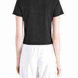 Black tee worn by a person, showing the tee fit